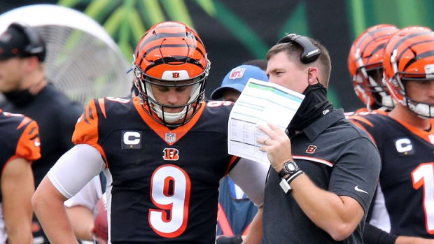 Cincinnati Bengals head coach Zac Taylor and Cincinnati Bengals quarterback Joe Burrow (9) talk during a timeout in the second quarter of a Week 1 NFL football game against the Los Angeles Chargers, Sunday, Sept. 13, 2020, at Paul Brown Stadium in Cincinnati. Los Angeles Chargers At Cincinnati Bengals Sept 13